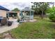 Landscaped backyard features a blue-trimmed gazebo for relaxing outdoors at 113 Maplewood Ave, Clearwater, FL 33765