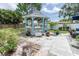 Backyard gazebo with mature trees and a patio for relaxing at 113 Maplewood Ave, Clearwater, FL 33765