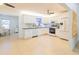 Modern kitchen with white cabinets, granite countertops, and stainless steel appliances at 113 Maplewood Ave, Clearwater, FL 33765