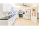 Bright kitchen with white cabinets, granite countertops and stainless steel appliances at 113 Maplewood Ave, Clearwater, FL 33765