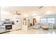 Open floor plan with kitchen flowing into a living room with a comfortable sectional sofa at 113 Maplewood Ave, Clearwater, FL 33765