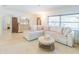 Comfortable living room featuring a large sectional sofa, neutral decor and lots of natural light at 113 Maplewood Ave, Clearwater, FL 33765