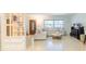 Cozy living room with a comfortable sectional sofa, decorative pillows, and a large window at 113 Maplewood Ave, Clearwater, FL 33765