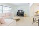 Bright living room featuring a plush sectional, stylish decor, and a connecting dining area at 113 Maplewood Ave, Clearwater, FL 33765