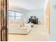 Inviting living room featuring a comfortable sofa, entertainment center, and natural light from the window at 113 Maplewood Ave, Clearwater, FL 33765