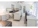 Open-concept living space with leather sofas, tiled floor, and adjoining kitchen with sink at 113 Maplewood Ave, Clearwater, FL 33765