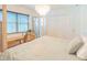 Spacious main bedroom features a canopy bed, hardwood floors, a crystal chandelier, and natural light at 113 Maplewood Ave, Clearwater, FL 33765