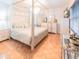 Beautiful main bedroom with hardwood floors, a canopy bed, chandelier, and neutral decor at 113 Maplewood Ave, Clearwater, FL 33765