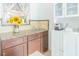 The office nook features granite counters, wood cabinets, sunflowers, and white upper cabinets at 113 Maplewood Ave, Clearwater, FL 33765