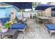 Charming outdoor patio area with comfortable seating, dining table, and shade umbrellas, perfect for outdoor gatherings at 113 Maplewood Ave, Clearwater, FL 33765