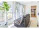 Relaxing sunroom features large windows, sheer curtains, comfortable seating, and bright decor to enjoy the sunlight indoors at 113 Maplewood Ave, Clearwater, FL 33765