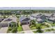 Aerial view of a single-Gathering home showcasing its well-maintained lawn, landscaping, and brick-paved driveway at 11315 Chilly Water Ct, Riverview, FL 33579