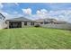 Spacious backyard featuring a well-maintained lawn and a screened-in patio at 11315 Chilly Water Ct, Riverview, FL 33579