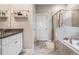 Bright bathroom with a walk-in shower, tub, and white cabinets offering style and comfort at 11315 Chilly Water Ct, Riverview, FL 33579