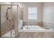 Bathroom featuring a separate shower and soaking tub for a spa-like experience at 11315 Chilly Water Ct, Riverview, FL 33579
