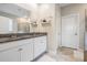 Well-lit bathroom with dual sink vanity, granite counters, walk-in shower, and tile flooring at 11315 Chilly Water Ct, Riverview, FL 33579