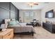 Bedroom features a dark accent wall, ceiling fan, and adjacent workspace with lots of natural light at 11315 Chilly Water Ct, Riverview, FL 33579