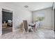 Bright dining room with tile floors adjacent to a bedroom, features a window for natural light at 11315 Chilly Water Ct, Riverview, FL 33579
