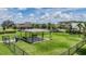 Community dog park with dog waste station, shaded bench, and playground in the background at 11315 Chilly Water Ct, Riverview, FL 33579