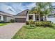 Charming single-Gathering home with a well-manicured lawn, beautiful landscaping, and a brick-paved driveway at 11315 Chilly Water Ct, Riverview, FL 33579