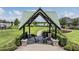 A gazebo with seating overlooks a lake with walking paths surrounded by green grass and landscaping at 11315 Chilly Water Ct, Riverview, FL 33579