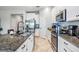 Bright kitchen featuring stainless steel appliances, white cabinetry, and granite countertops at 11315 Chilly Water Ct, Riverview, FL 33579