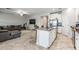 Spacious living room featuring tile floors, a ceiling fan and a large sectional sofa at 11315 Chilly Water Ct, Riverview, FL 33579