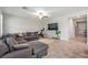 Cozy living room showcases a large sectional sofa, TV, exercise bike and lots of natural light at 11315 Chilly Water Ct, Riverview, FL 33579