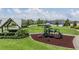Neighborhood playground and splash pad with a covered seating area and lush green grass at 11315 Chilly Water Ct, Riverview, FL 33579