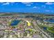 Drone view of home location with lake, road and surrounding houses marked with an arrow indicating direction and area at 11327 Brighton Knoll Loop, Riverview, FL 33579