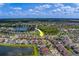 Wide aerial shot shows property location and neighborhood with lakes, sky, and surrounding residential area marked with an arrow at 11327 Brighton Knoll Loop, Riverview, FL 33579