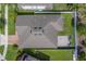 Aerial view showcasing the home's layout, roof, paver patio, and well-maintained backyard at 11327 Brighton Knoll Loop, Riverview, FL 33579
