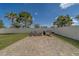 Backyard with a paver patio, fire pit, grill, and a white fence, offering a private outdoor space at 11327 Brighton Knoll Loop, Riverview, FL 33579