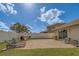 Beautifully landscaped backyard with a paver patio, outdoor seating, and a cozy fire pit at 11327 Brighton Knoll Loop, Riverview, FL 33579