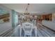 Bright dining room features wood floors and decorative white table and chairs at 11327 Brighton Knoll Loop, Riverview, FL 33579