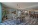 Dining room with modern chandelier, large beach-themed painting, and view to the kitchen at 11327 Brighton Knoll Loop, Riverview, FL 33579