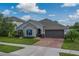 Attractive single-Gathering home with a well-maintained yard, brick driveway, and a two-car garage at 11327 Brighton Knoll Loop, Riverview, FL 33579