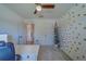 Neutral home office features a modern desk, a ceiling fan, and a charming decorative tree at 11327 Brighton Knoll Loop, Riverview, FL 33579