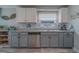Kitchen with gray cabinets, granite counters, and stainless-steel appliances at 11327 Brighton Knoll Loop, Riverview, FL 33579