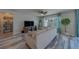 Bright living room featuring neutral paint, modern decor, a ceiling fan, and large windows at 11327 Brighton Knoll Loop, Riverview, FL 33579