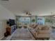Comfortable living room with modern decor, ample seating, and large windows at 11327 Brighton Knoll Loop, Riverview, FL 33579
