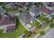 Aerial view of a home showcasing its backyard patio with outdoor seating and well-manicured lawn, surrounded by a white fence at 11327 Brighton Knoll Loop, Riverview, FL 33579