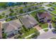 Drone shot of the property revealing the backyard with patio and surrounding landscape, complemented by nearby roadways and pond at 11327 Brighton Knoll Loop, Riverview, FL 33579