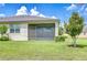 Back of the house featuring a screened in patio and large yard at 11619 Cambium Crown Dr, Riverview, FL 33569