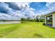 Picturesque backyard with green grass and a beautiful lake view, offering a serene outdoor space at 11619 Cambium Crown Dr, Riverview, FL 33569