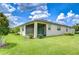 Exterior view of a home with a spacious, well-manicured lawn and screened-in patio area at 11619 Cambium Crown Dr, Riverview, FL 33569