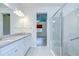 Bathroom featuring double vanity and walk in shower with tiled walls at 11619 Cambium Crown Dr, Riverview, FL 33569