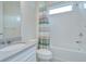 Bathroom featuring a bathtub with white tiled walls and a vanity sink with natural light at 11619 Cambium Crown Dr, Riverview, FL 33569