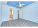 Spacious bedroom with a blue coffered ceiling and wood-look flooring at 11619 Cambium Crown Dr, Riverview, FL 33569