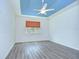 Bedroom with trey ceiling, ceiling fan, a window, and wood-look flooring at 11619 Cambium Crown Dr, Riverview, FL 33569